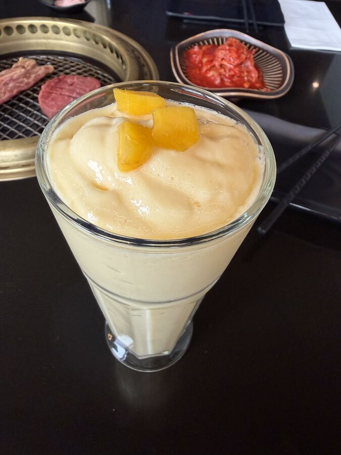 Mango coconut yogurt shake topped with fresh mango